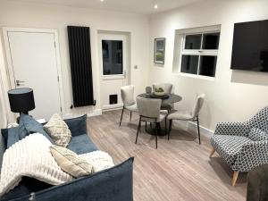 a living room with a couch and a table at Field Apartment in Douglas