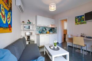 a living room with a couch and a table at Apartment Lauro Opatija, ground floor, parking, near sea in Opatija