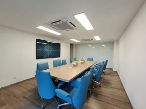 a conference room with a table and blue chairs at -30 OFF Monthly l Premium Muji 1BR Suites in Kuala Lumpur +24 photos