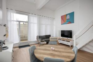 ブレストにあるDuplex au calme à deux pas du centre-ville avec Parking privatif et Terrasseのリビングルーム(木製テーブル、テレビ付)