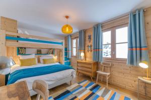 a bedroom with a bed and a desk at Klochette - Charme Et Famille in Villard-Reculas