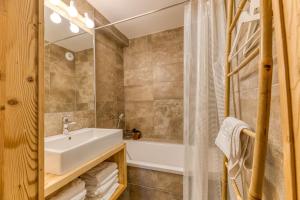 a bathroom with a sink and a bath tub at Klochette - Charme Et Famille in Villard-Reculas +28 photos