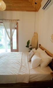 a bedroom with a white bed with a window at Studio Morell in Ahangama +5 photos
