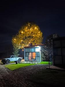 a car parked in front of a house at night at Cabañas pareja Tapalpa LUNA AZUL in Tapalpa +6 photos