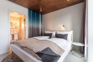 Voodi või voodid majutusasutuse EMA House Hotel Suites toas