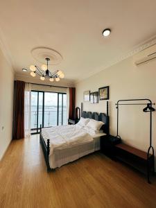a bedroom with a bed and a chandelier at Ocean View Family Suite in Johor Bahru +50 photos