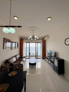 a living room with a couch and a table at Ocean View Family Suite in Johor Bahru