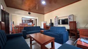 a living room with blue chairs and a table at Amani House - Bed and Breakfast in Arusha