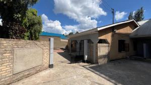 a brick building with a gate and a fence at Amani House - Bed and Breakfast in Arusha