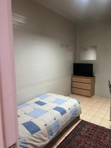 a bedroom with a bed and a flat screen tv at Prenociste Pecinci in Pećinci
