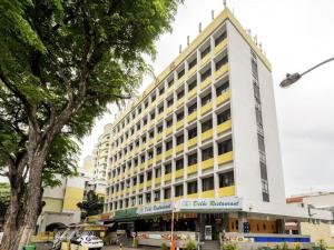 a building with a yellow and white building at The Quay Hotel Little India at Broadway in Singapore