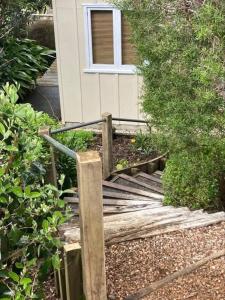 a wooden bridge in front of a house at Waiwurri - at the Beach in Palm Beach
