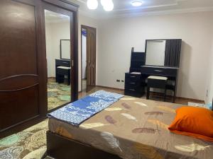a bedroom with a bed and a dresser and a mirror at Asyut Cozy Nile view apartment in Asyut