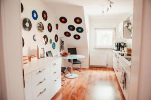 a kitchen with a table and records on the wall at Ferienwohnung "Helden" in Marklohe