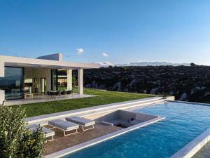 a villa with a swimming pool and a house at Blue Olive Luxury Villa in Kounoupidhianá