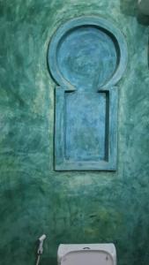 a painting of a window above a toilet in a bathroom at Lala House by Masala Living in Jambiani +30 photos