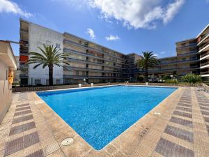 a large swimming pool in front of a building at Mediterranean Way - Pineda 1 in La Pineda