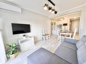 a living room with a couch and a table at Mediterranean Way - Pineda 1 in La Pineda