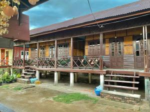 a building with a bench in front of it at Suns down 2 bungalows dondet in Don Det +12 photos