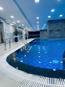 a large swimming pool in a building at Dubai Marina - 1BHK Apartment in Dubai