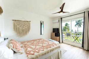 a bedroom with a bed and a window with a view at Le PARADIS BLEU VUE MER in Saint-François +9 photos