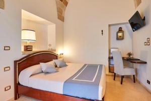 Letto o letti in una camera di Corte Di Nettuno - CDSHotels