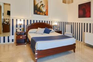Letto o letti in una camera di Corte Di Nettuno - CDSHotels