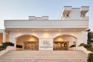 a building with stairs in front of a store at Grand Hotel Riviera - CDSHotels in Santa Maria al Bagno