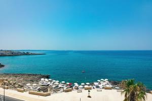 a view of a beach with umbrellas and the ocean at Grand Hotel Riviera - CDSHotels in Santa Maria al Bagno