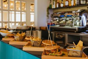 a buffet with sandwiches and chips on a counter at Grand Hotel Riviera - CDSHotels in Santa Maria al Bagno