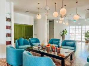 a waiting room with blue chairs and a table at Grand Hotel Riviera - CDSHotels in Santa Maria al Bagno