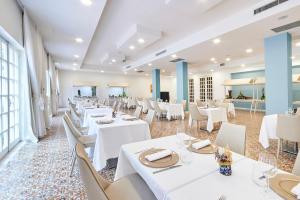 a dining room with white tables and white chairs at Grand Hotel Riviera - CDSHotels in Santa Maria al Bagno