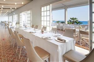 a conference room with tables and chairs and the ocean at Grand Hotel Riviera - CDSHotels in Santa Maria al Bagno
