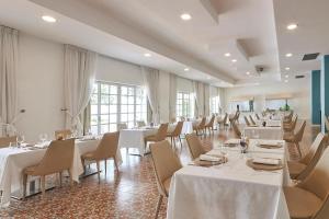 a dining room with white tables and chairs at Grand Hotel Riviera - CDSHotels in Santa Maria al Bagno