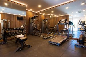 a gym with several tread machines and a mirror at Grand Hotel Riviera - CDSHotels in Santa Maria al Bagno