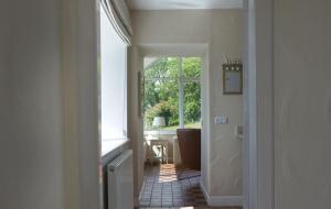 a hallway with a bathroom with a window at Bardristane Forge in Gatehouse of Fleet +6 photos