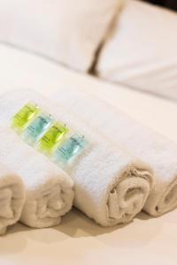 a pile of towels sitting on top of a bed at The Monet - Chic 1 bd Apt -Gold Short Term Stays in Belfast