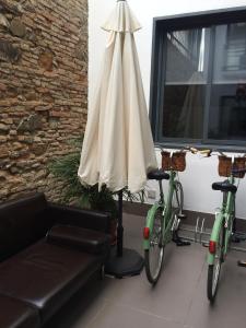 two bikes parked next to a couch and an umbrella at Apartamentos San Pablo in Málaga
