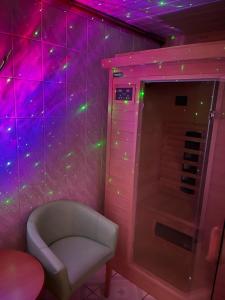 a room with a white chair and purple lights at Dom na Karkonoskiej in Karpacz +52 photos
