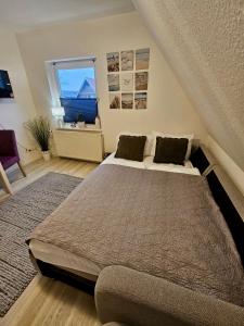 a bedroom with a large bed and a window at Gemütliches Sylter Strandstudio in Sylt