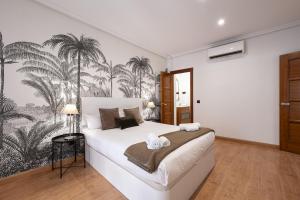 Postel nebo postele na pokoji v ubytování Madrid Centric Suites