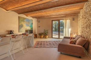 Una sala de estar con un sofá y una cocina. en Donna Tosca Country Holiday Home, en Suvereto