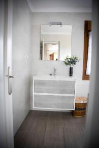 a bathroom with a sink and a mirror at Playa del Silencio 1 in Castañeras