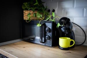 a microwave sitting on a table with a yellow mug at Playa del Silencio 1 in Castañeras