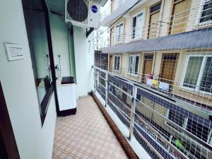 a balcony of a building with a bird cage at Heaven Vibes Stays in Rishīkesh