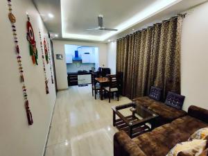 a living room with a couch and a table at Heaven Vibes Stays in Rishīkesh