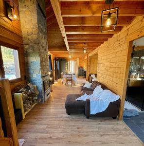 a living room with two couches in a log cabin at Chalet cosy Francorchamps in Stavelot