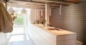 a kitchen with a white counter in a room at Blanc Sable Hôtel in Golfe-Juan +58 photos