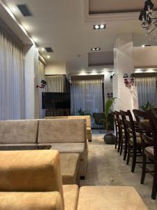 a waiting room with couches and a table and chairs at ESPERIA Drama HOTEL in Drama