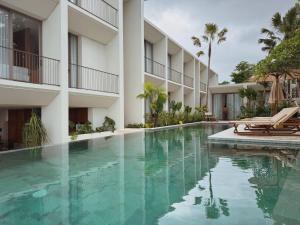 a swimming pool in front of a building at SOKO' Stay at Kedungu in Tanah Lot